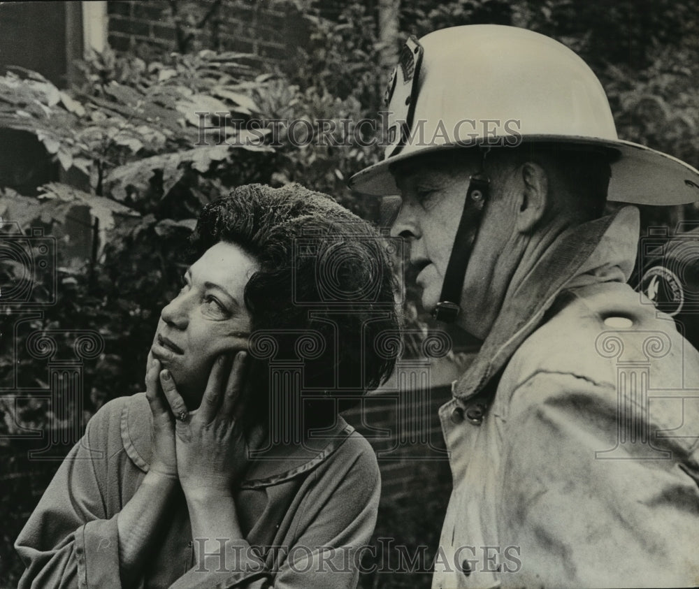 1970, Alabama-Woodlawn woman looks back at burned-out apartment. - Historic Images