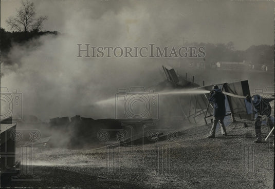1971 Alabama-Birmingham firemen pour water on shopping center blaze. - Historic Images