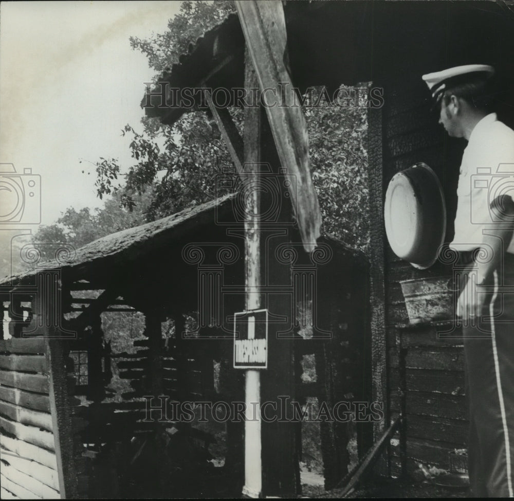 1974 Alabama McDanal looks over workshed after  Baldwin home fire. - Historic Images