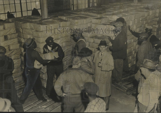 1961 Volunteers unload shipment of government food, Jefferson County-Historic Images