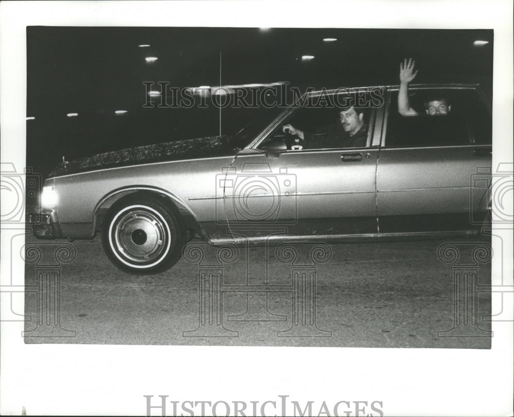  Man waves from car at Talledega, Alabama - Historic Images