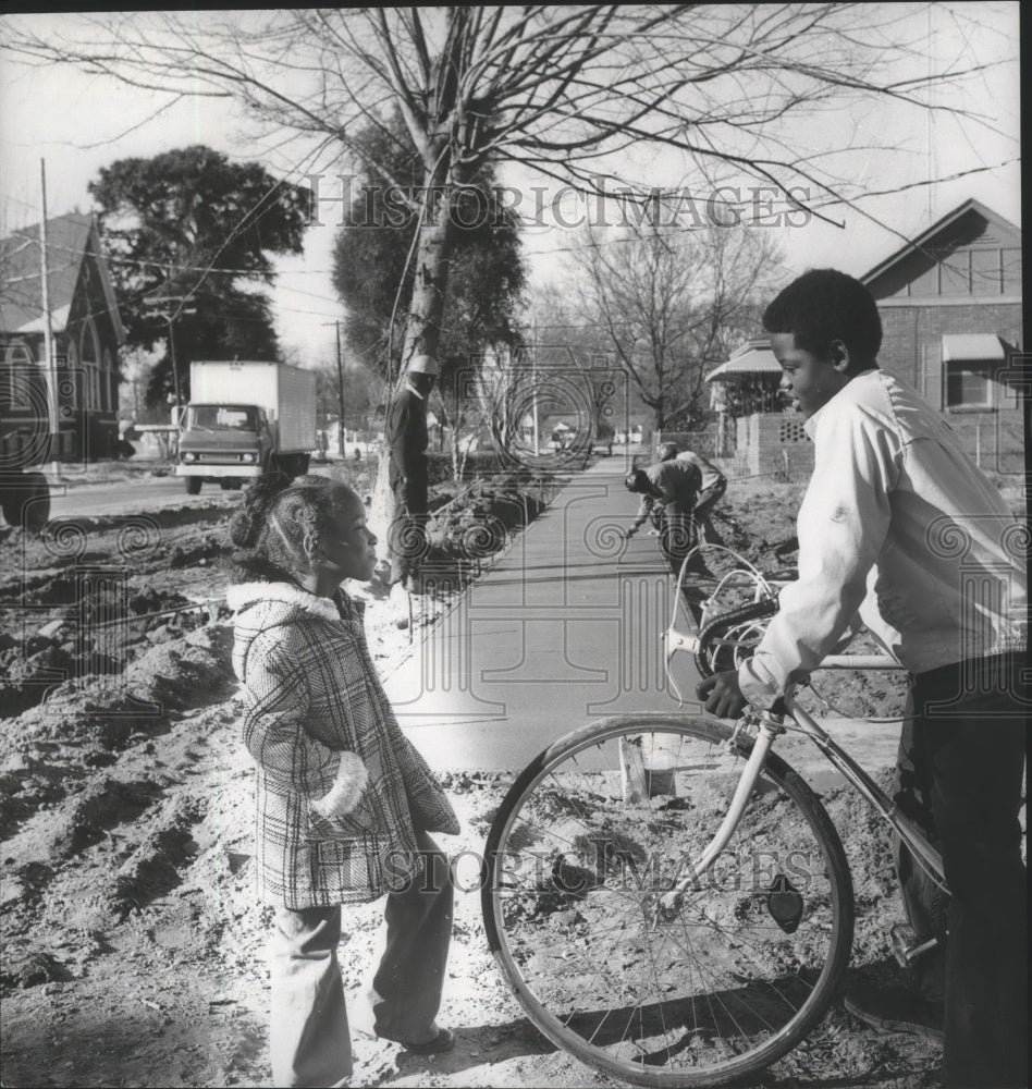 1975 Children watching workers lay out new sidewalks, Selma, Alabama-Historic Images