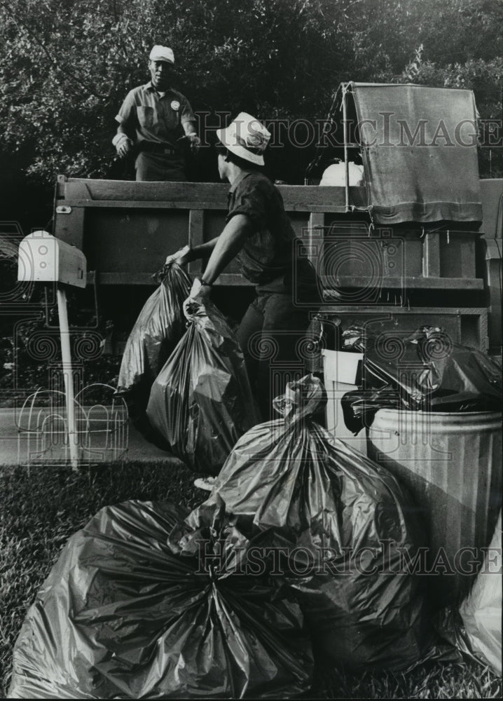 1975, Bags of garbage being picked up hauled away, Birmingham - Historic Images