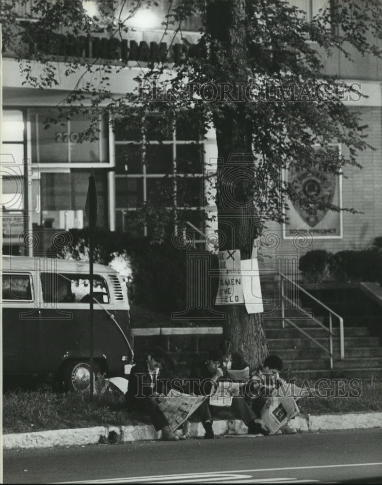 1979, Employees on strike sit with newspaper in Birmingham, Alabama - Historic Images