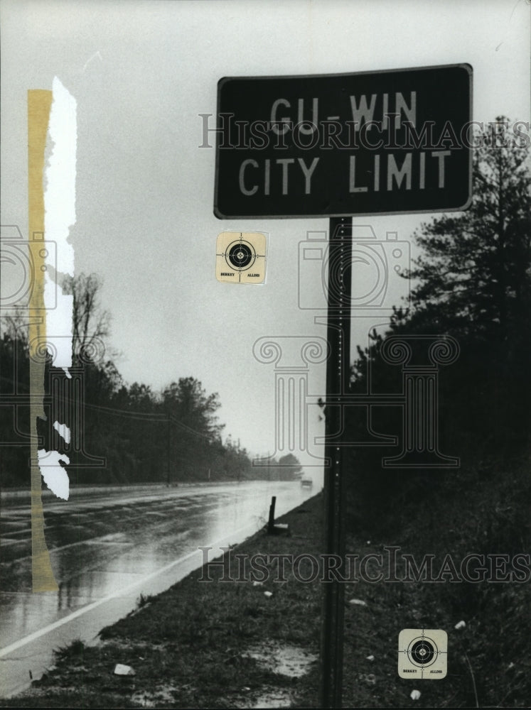 1980 Gu-win City Limit sign along road into Gu-win, Alabama - Historic Images