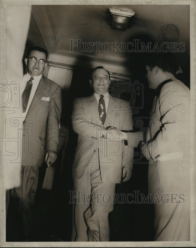 1955 Press Photo Albert Fuller shakes hands with reporter in court - abna13467- Historic Images