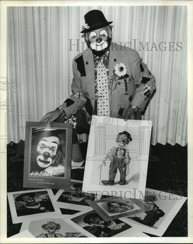 1981, Clown John Ingle holds clown photographs - abna13825 - Historic Images