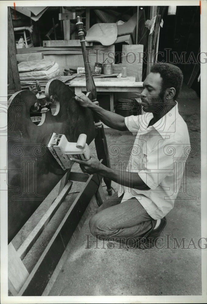 1981 Bush Leonard sanding a headboard for a bed - Historic Images