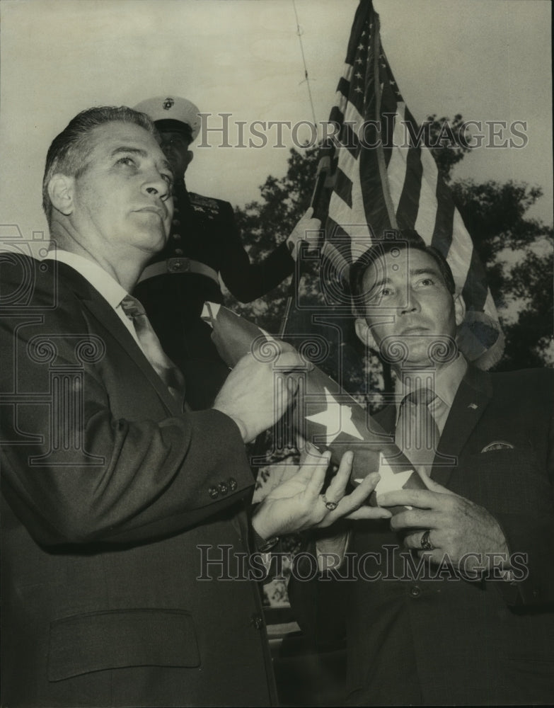 1970 Woods, Flag avenue chairman, gets flag from Joe King, Fairfield - Historic Images