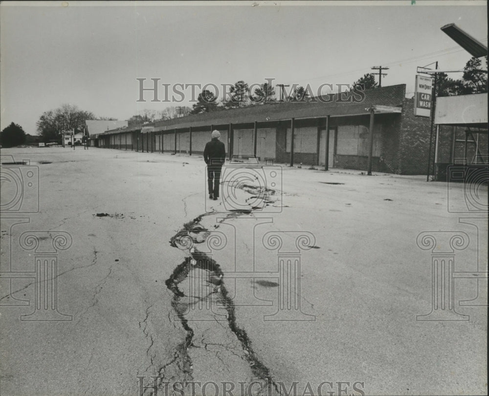 1982, man standing next to road damage, Graysville, Alabama - Historic Images