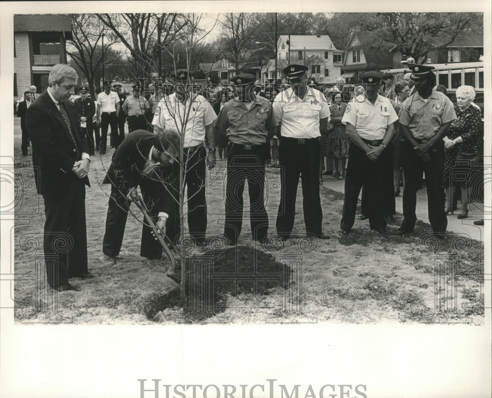 1985 Firemen plant tree to honor fallen firefighter, Alabama - Historic Images