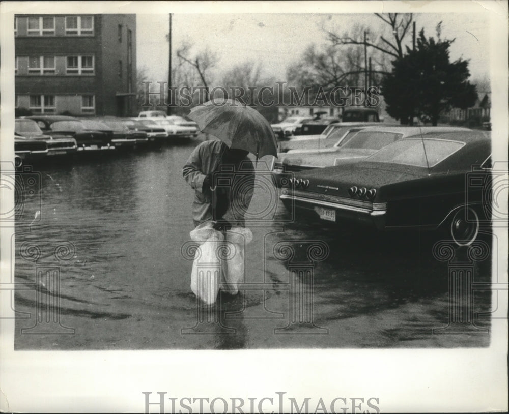 1970, Person walking with Umbrella and Bags in Flooded Birmingham - Historic Images