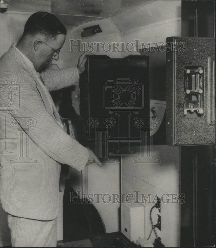 1957 K. W. Grimley examines rapid X-ray picture taker in Jefferson-Historic Images