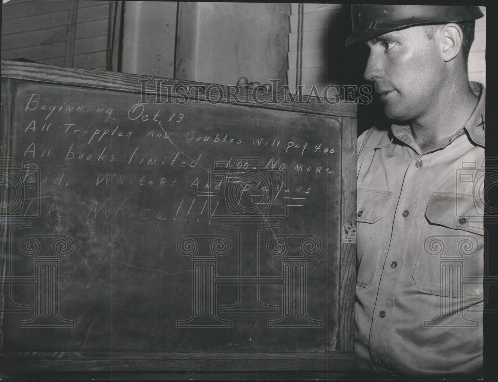 1954 Press Photo Mallory Hammonds looks at Lottery Odds Payoff Board Seized - Historic Images