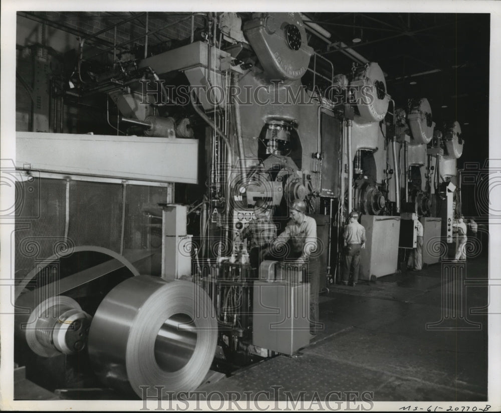Workers in plant with large equipment - Historic Images