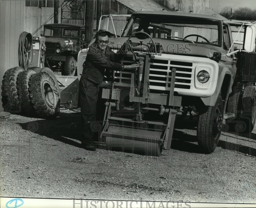 1981 Griggs' Bull Roller attached to truck - Historic Images