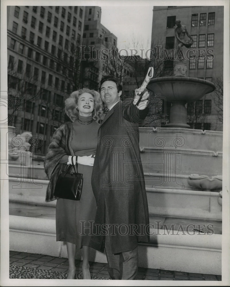 1957, Jeanne Moody and husband Scott Forbes stand by statue - Historic Images