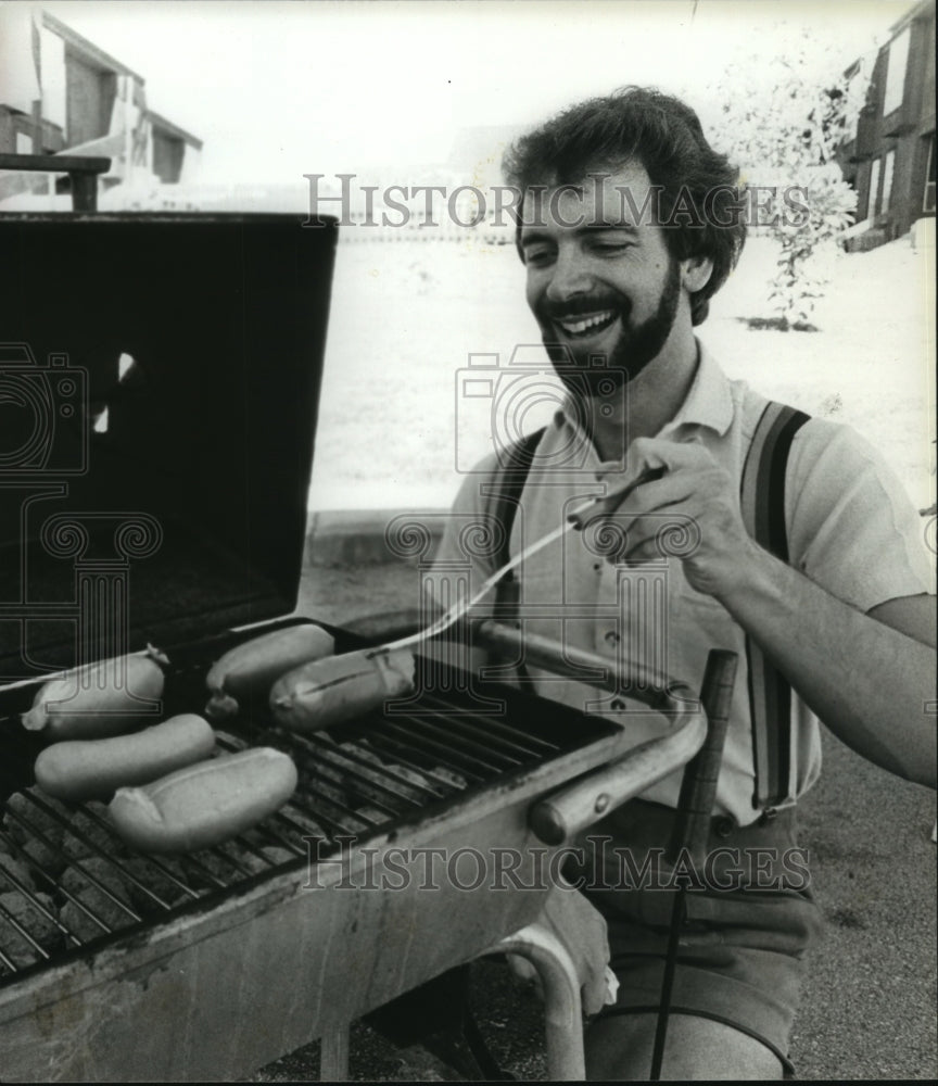 1979 Steve Heaton cooks at German Oktoberfest in Center Point - Historic Images