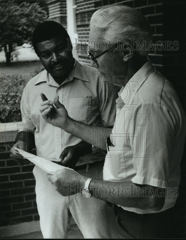 1981, Sumter registrar T. A. Markham and Wendell Paris discuss voting - Historic Images