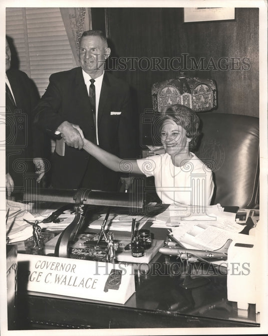 1966, Mrs. Wallace tries out Gov. George Wallace's chair in Alabama - Historic Images