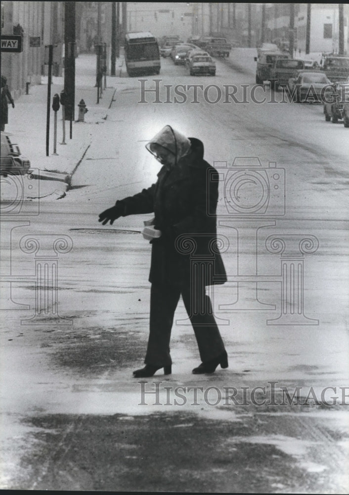 1982 Lady crossing icy 23rd Street at 5th Avenue, North, Alabama - Historic Images