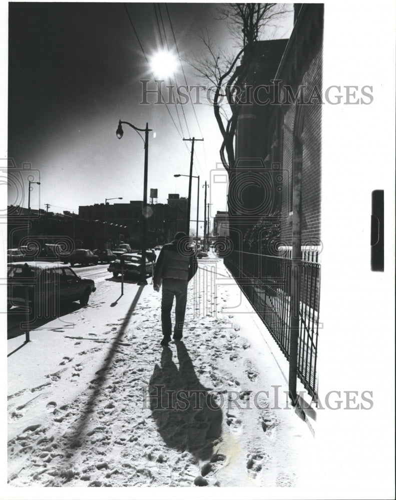 1982 Unidentified man walking along snowy sidewalk, Alabama - Historic Images