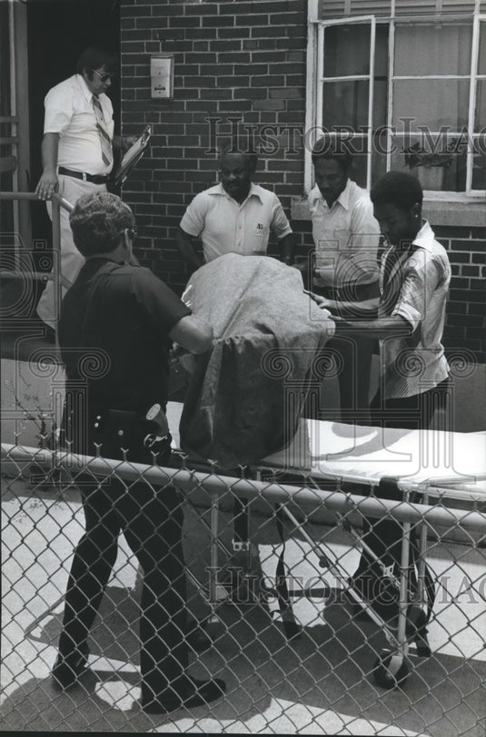 1980, Victim of Monday's heat carried from apartment, Alabama - Historic Images
