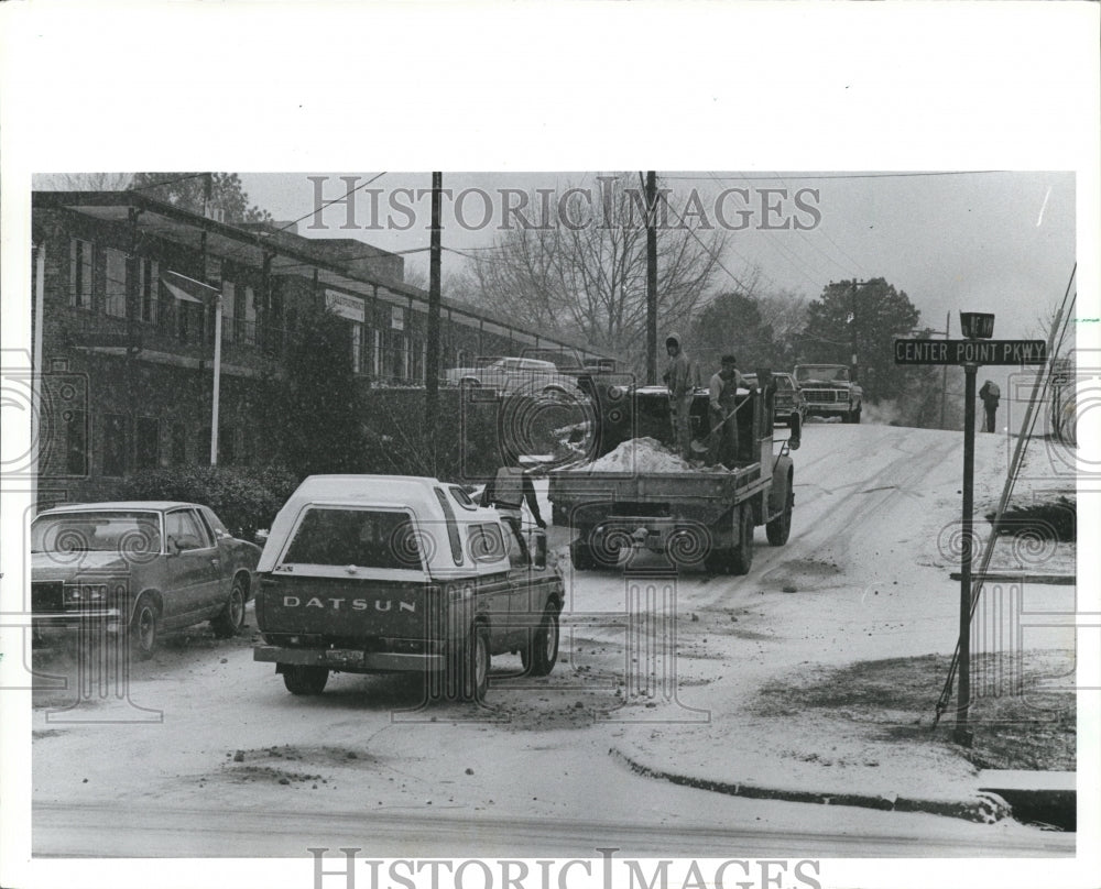 1982 Workers put sand on snowy Center Point Parkway - Historic Images