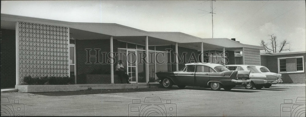 1963, Man Sitting in front of Clinic in Arab, Alabama - abna17987 - Historic Images