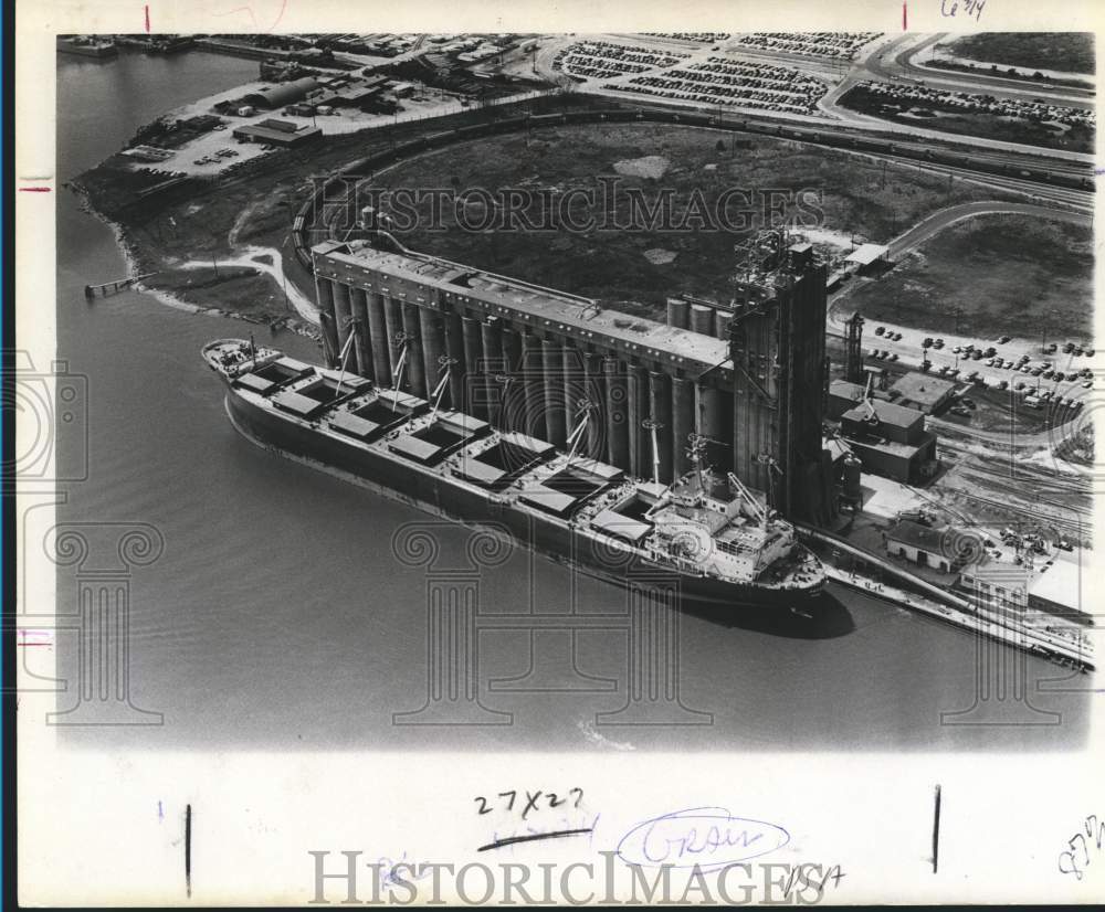 Grain elevator on waterfront with ship, aerial view - Historic Images