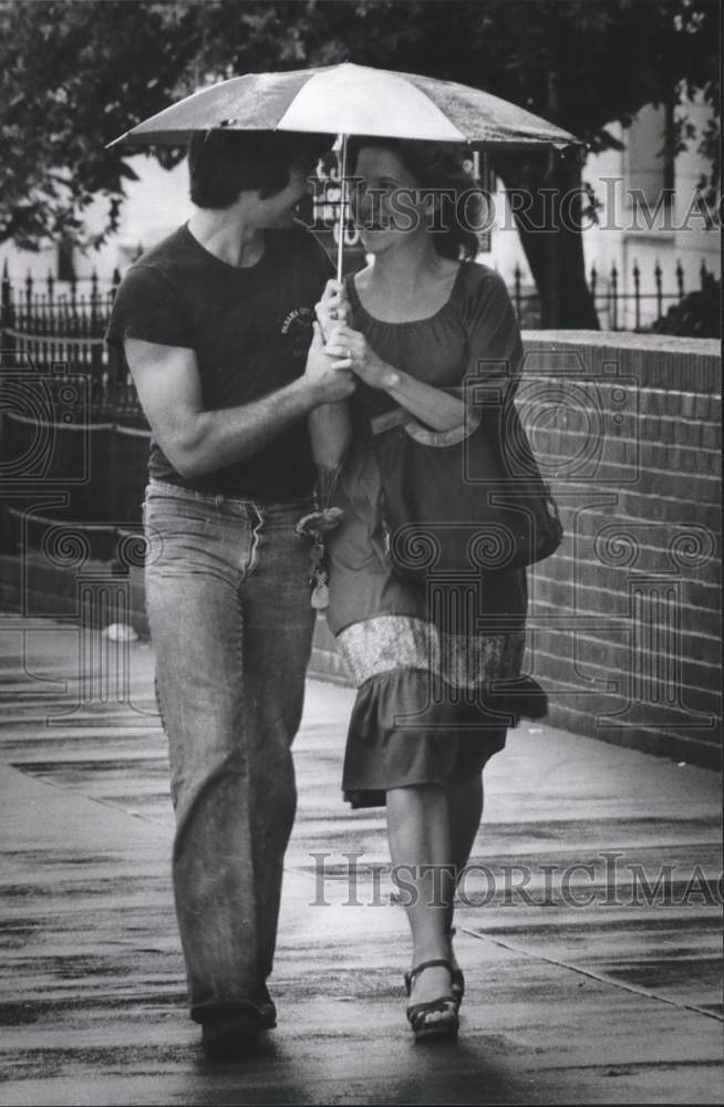 1979 Press Photo Couple Walking Under Umbrella During Rain Shower - abna18600 - Historic Images