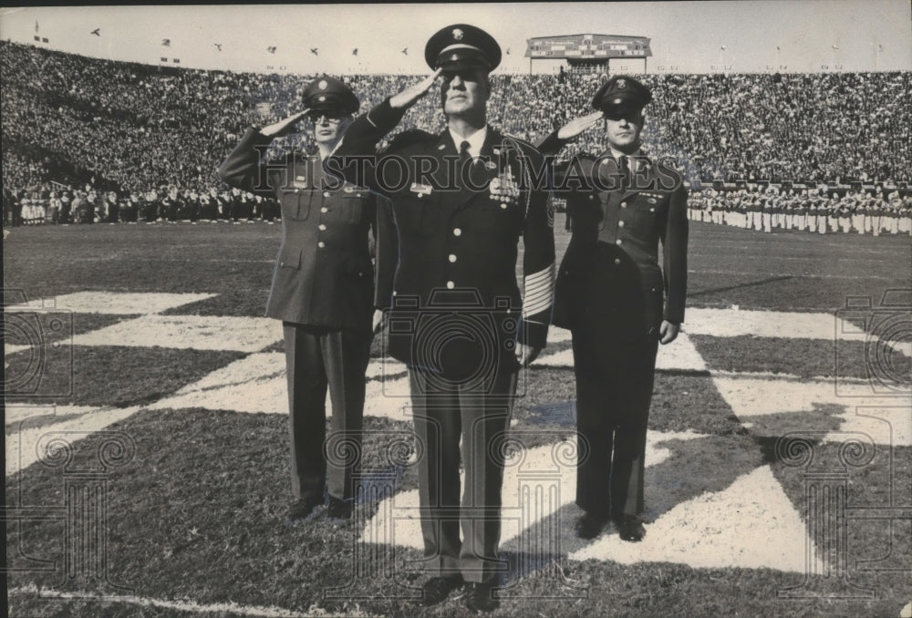 1965, Sergeant Major William Wooldridge salutes at stadium - Historic Images