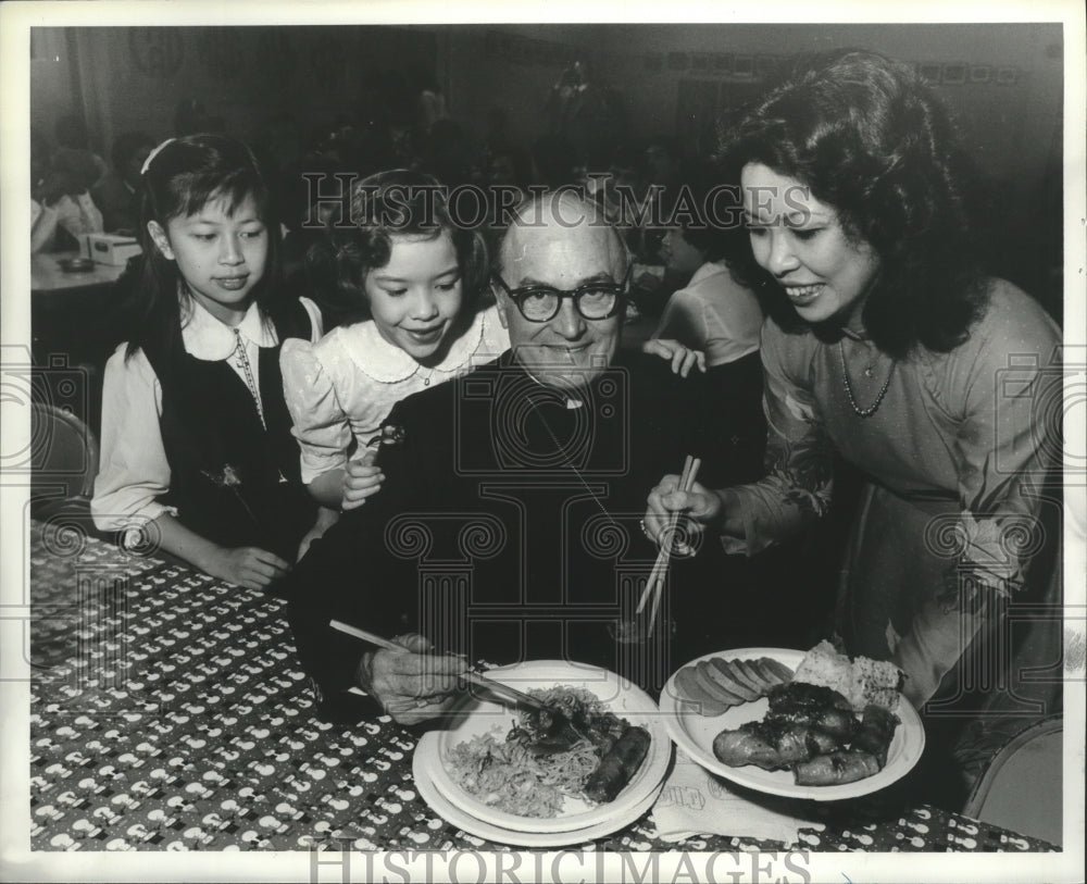 1981 Bishop Vath, others,  is served Vietnamese dishes, Alabama - Historic Images
