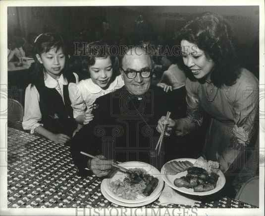 1981 Bishop Vath, others,  is served Vietnamese dishes, Alabama - Historic Images