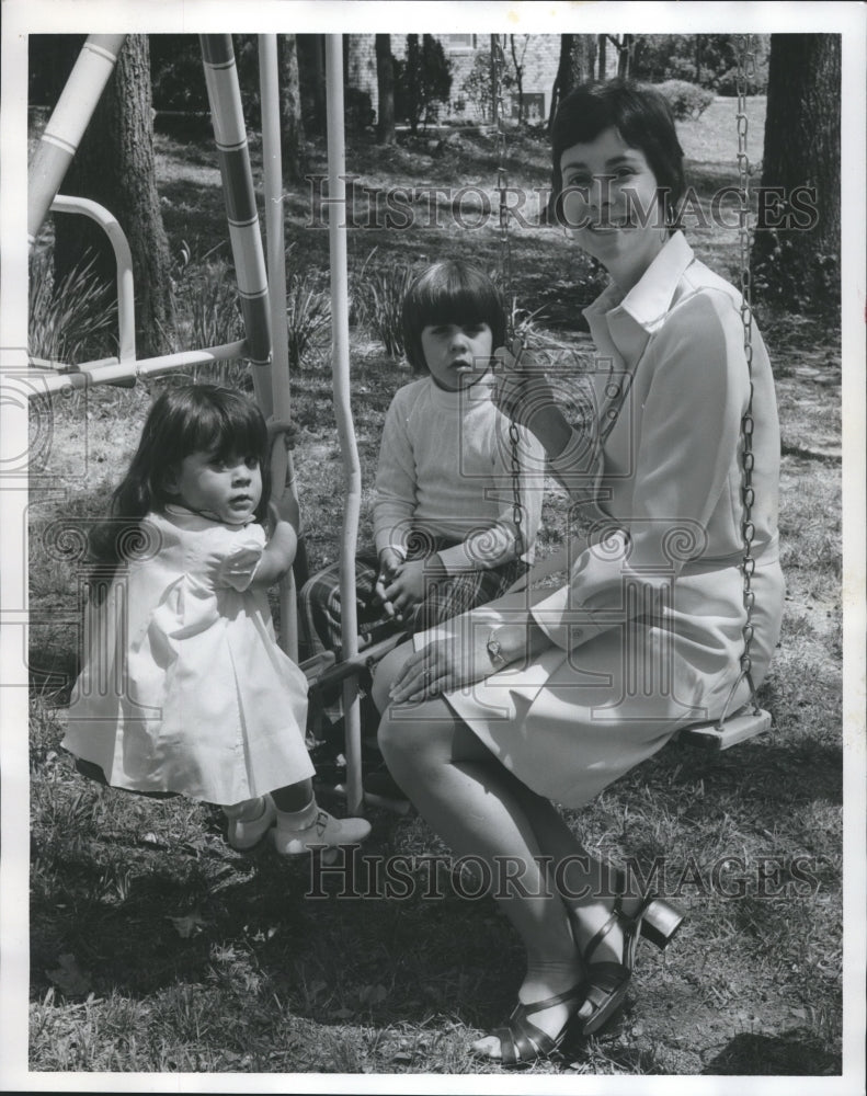 1974, Suzanne Woodall plays with son and daughter - abna19926 - Historic Images