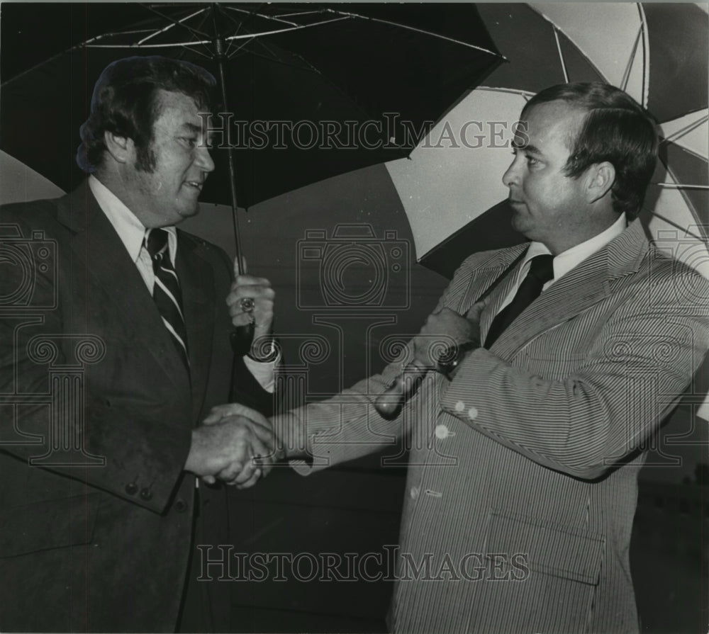 1976, State Highway Director Ray Bass shakes hands with Nathan Mathis - Historic Images