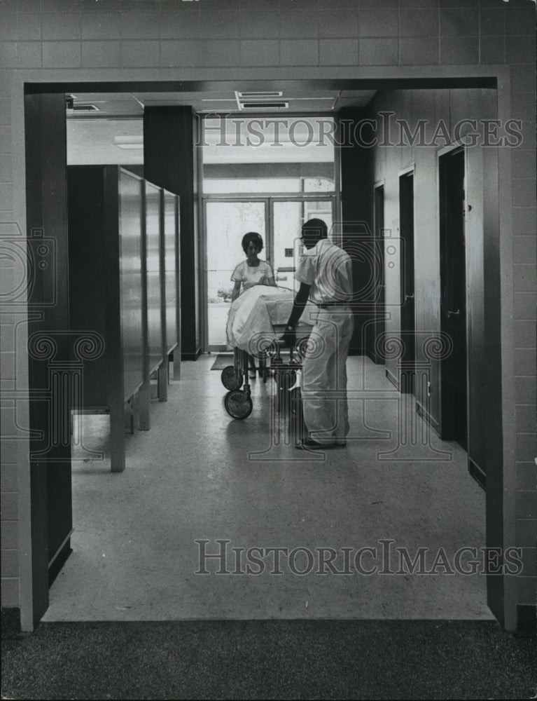 1966 Press Photo Patient brought in on gurney at University Hospital, Birmingham-Historic Images