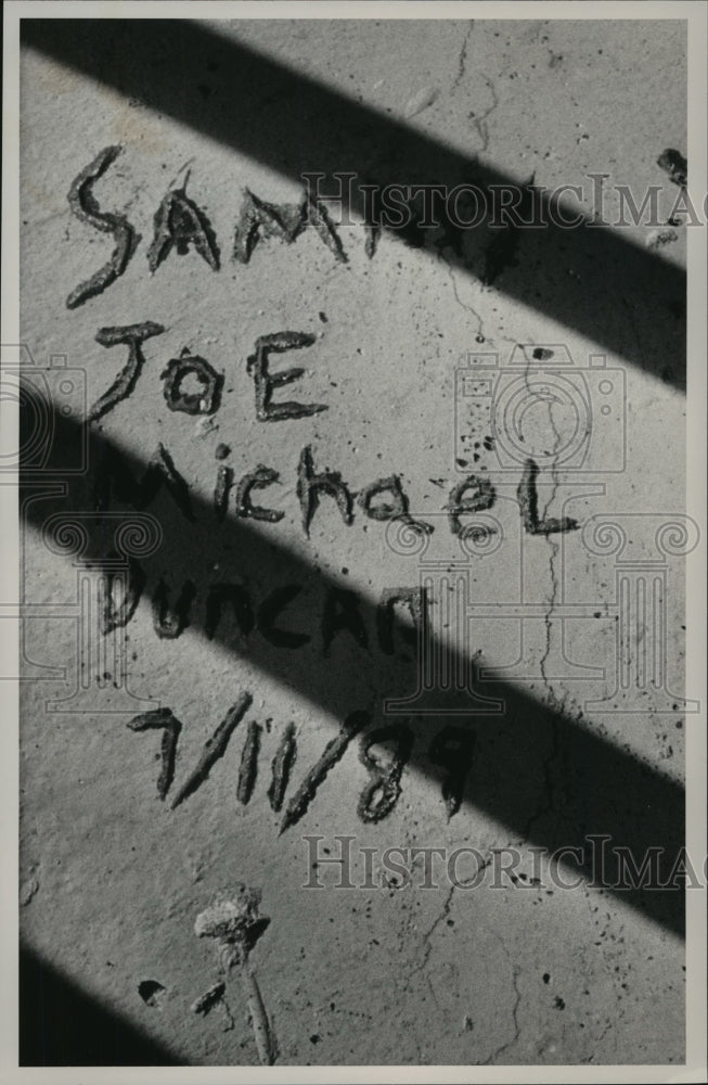 1989, Sammy Joe Duncan named etched in jail cell, Bibb County - Historic Images