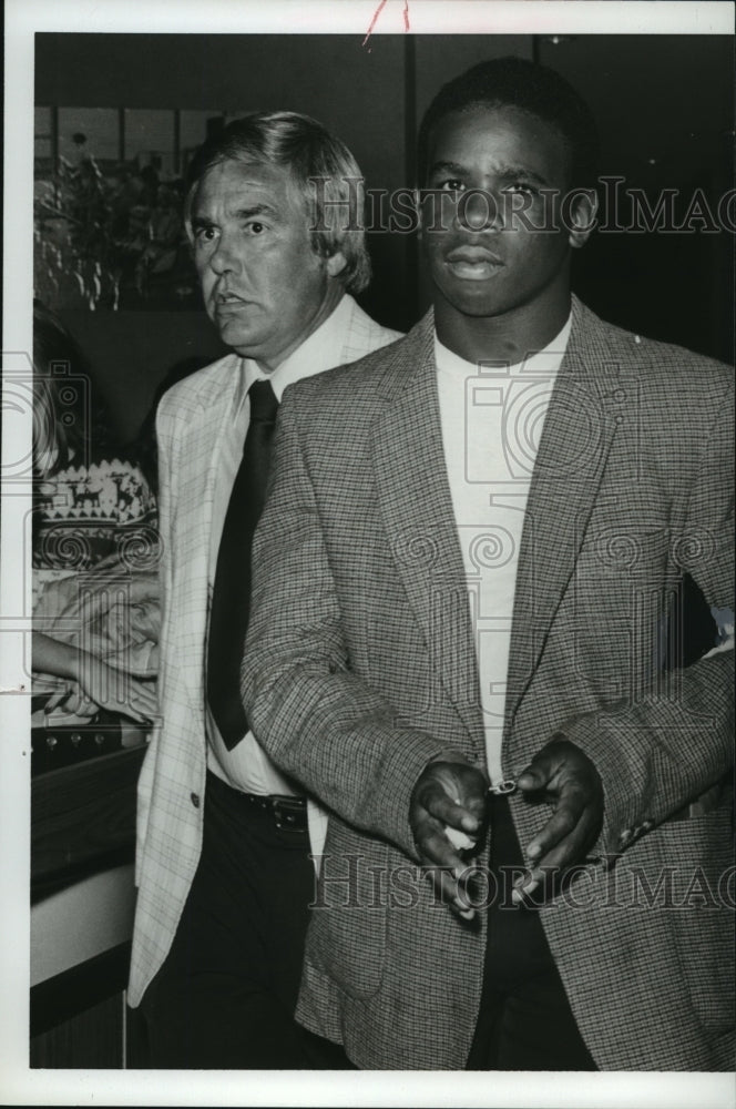 1981, Suspect Ralph Bighames is escorted by Sergeant Miller - Historic Images