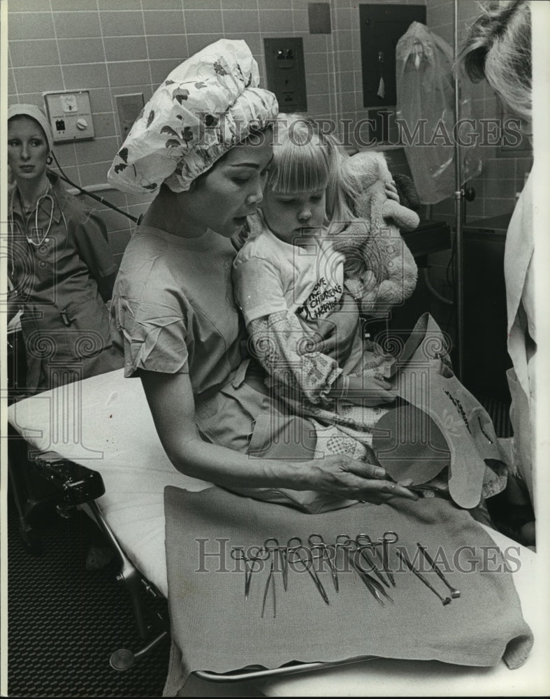 1979, Corazon Puzon shows child medical tools in Birmingham hospital - Historic Images