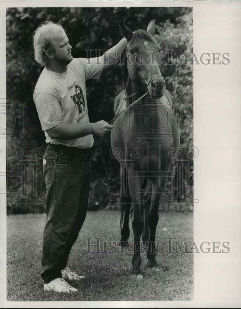 1989, Walter Bryant pets his adopted Humane Society horse in Bessemer - Historic Images