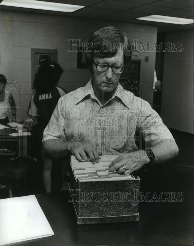 1981, Principal Dr. Ed Belue looks at records - abna21352 - Historic Images