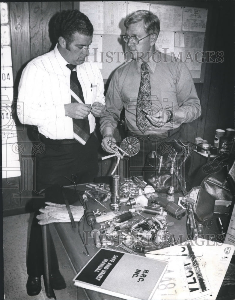 1978, Birmingham police Lt. Hudson and Sgt Copeland examine items - Historic Images