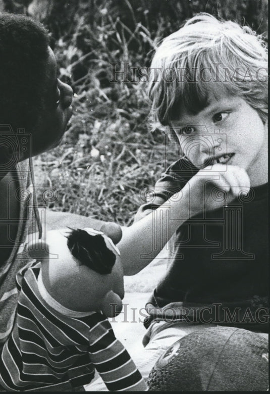 1978 Student Terrance Parker Entertains Michael Stanfield at picnic - Historic Images