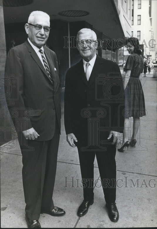 1963, Merchant Mervin Blach stands with H. W. Fisch outside store - Historic Images