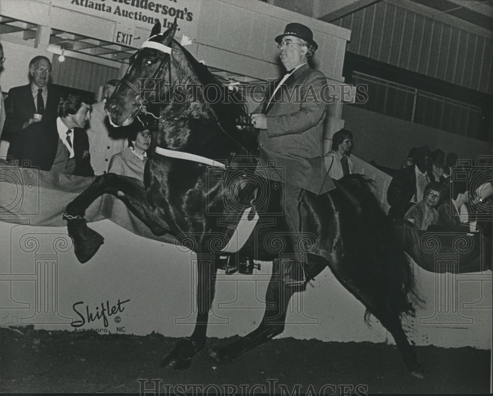 1983, Dr. Buris Boshell rides horse in competition - abna22440 - Historic Images