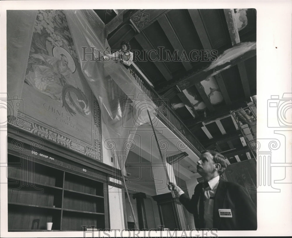 1985, Libby Flynn and Jack Bulow check mural at the library, Alabama - Historic Images