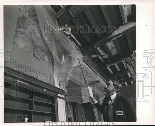 1985, Libby Flynn and Jack Bulow check mural at the library, Alabama - Historic Images