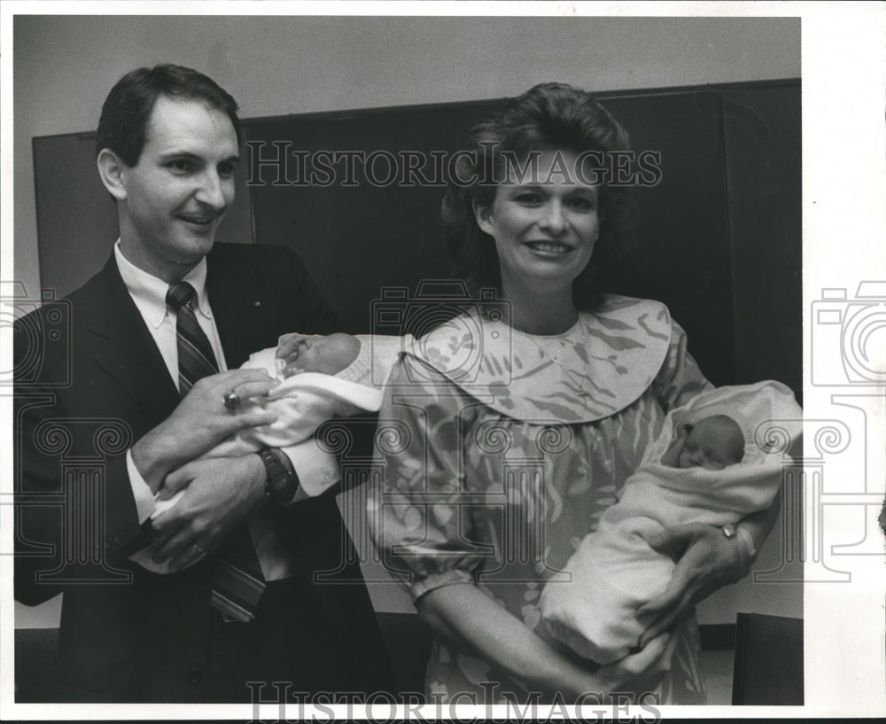 1988, Mark and Rhonda Brinton holding Ashley and Laura Erin, twins - Historic Images