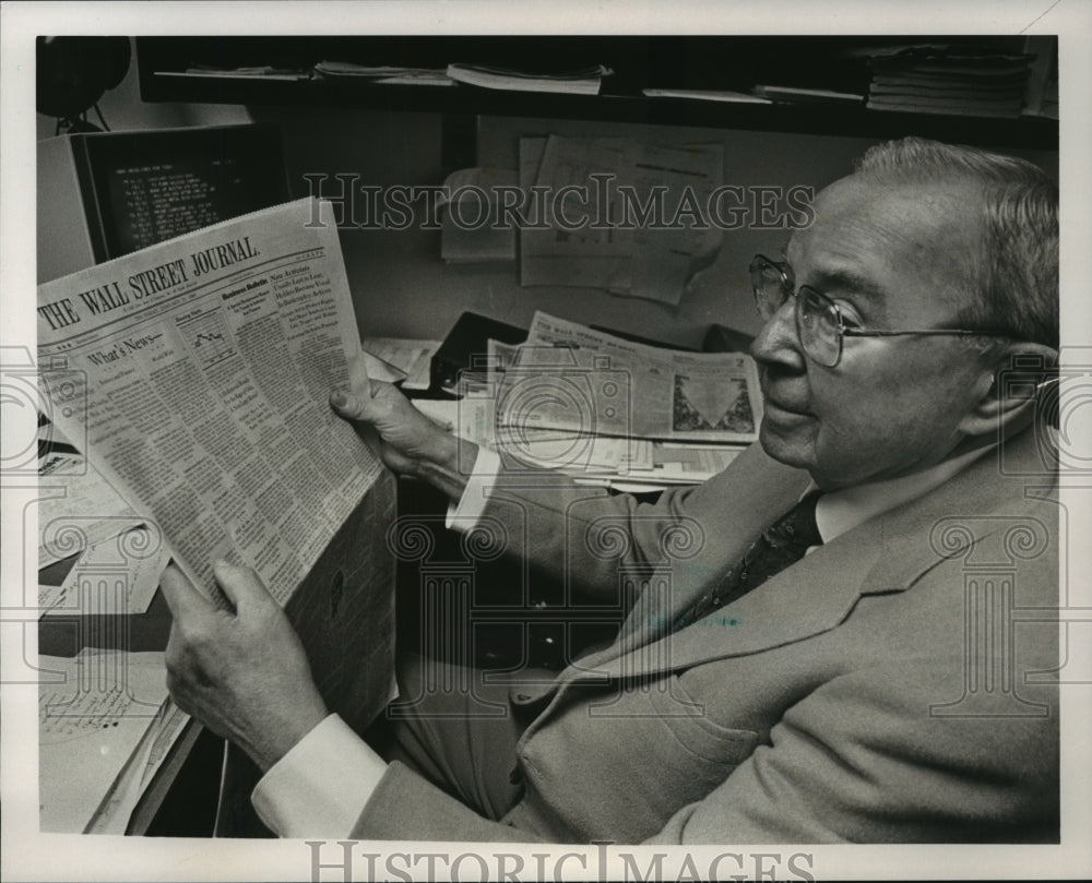 1988 Stockbroker Clyde Ulmer reads newspaper at desk-Historic Images